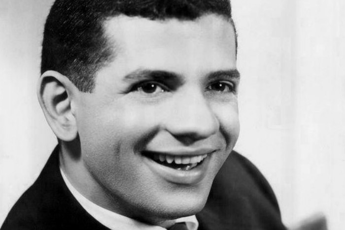Black and white image of a young and smiling TV star Robert Clary