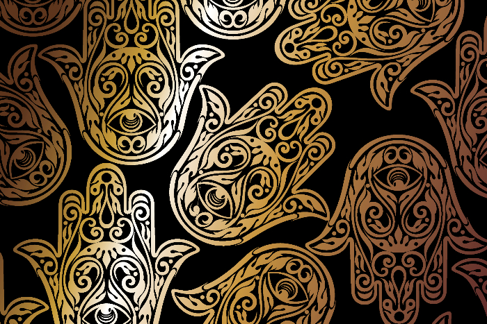 Ornate gold hamsas on a black background