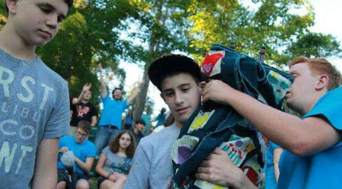 Teens at Reform Jewish summer camp carrying the Torah