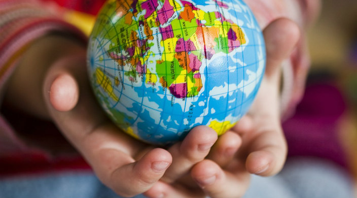 Childs hands holding a small globe