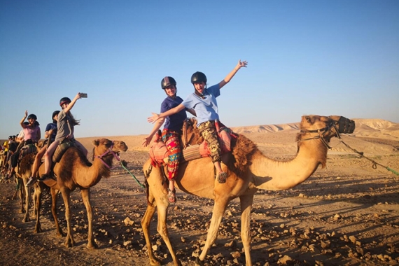 NFTY in Israel participants riding camels
