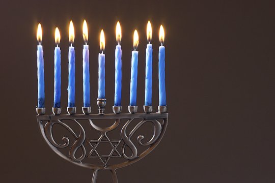 a hanukkah menorah with all nine candles lit