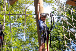 camper enjoying the ropes course at URJ Crane Lake Camp